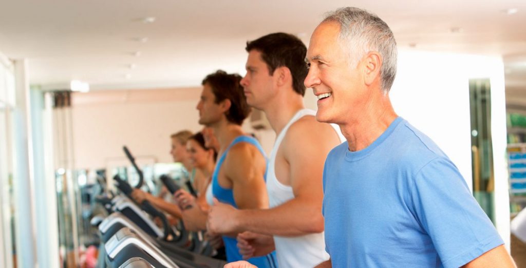 Men running on treadmill in a gym looking after their health and fitness