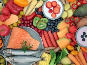 Healthy food consisting of salmon, fruit and vegetables
