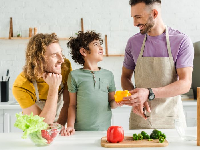 Men and boy preparing healthy food in kitchen